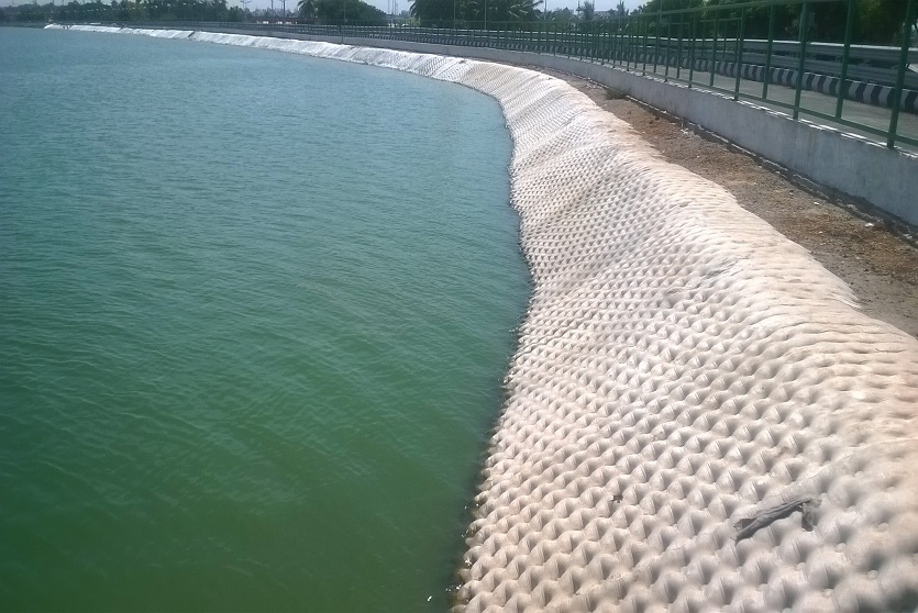 The geotextile, TechRevetment™ formed concrete mattresses, pictured on the side of a lake. Part of the geosynthetics solutions for erosion control.