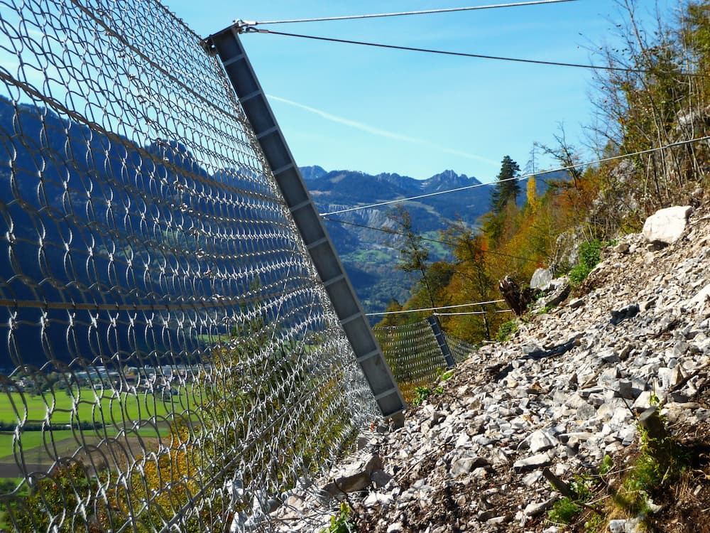 Slope stabilisation nets & rockfall barriers: Pictured rockfall fence on a hillside.