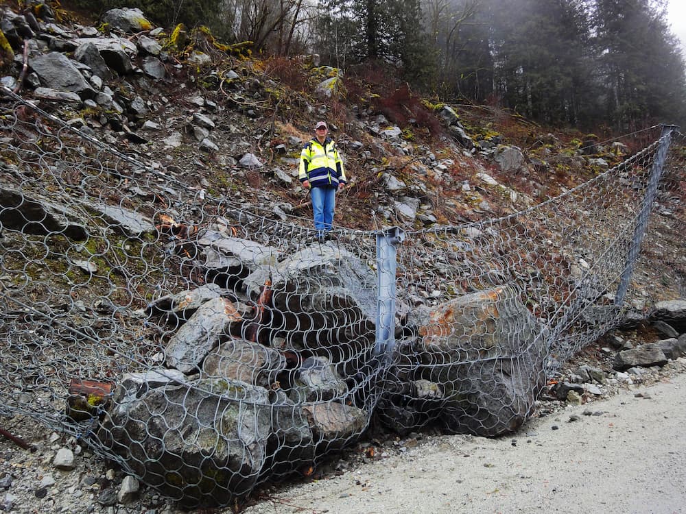 Slope stabilisation nets & rockfall barriers: Pictured a rockfall protection fence with rocks caught in the wire mesh.