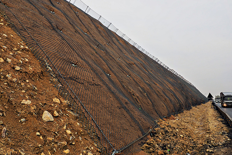 Slope stabilisation nets & rockfall barriers: Pictured slope stabilisation net alongside a road