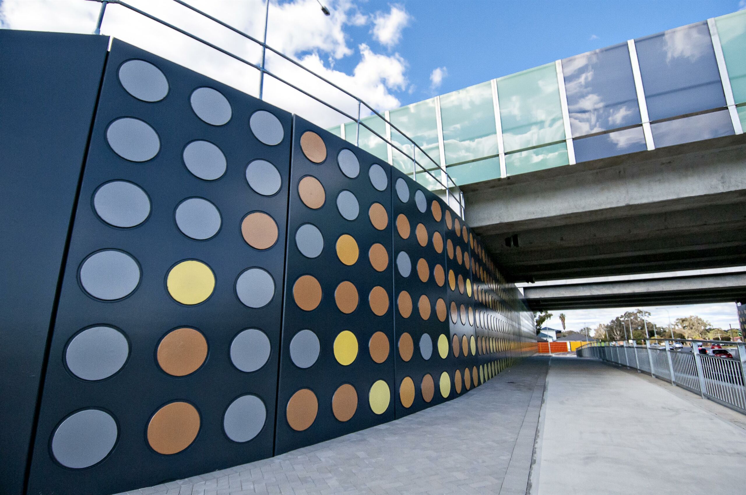 TerraTilt precast concrete retaining walls with multicoloured facade alongside a new cycle path.