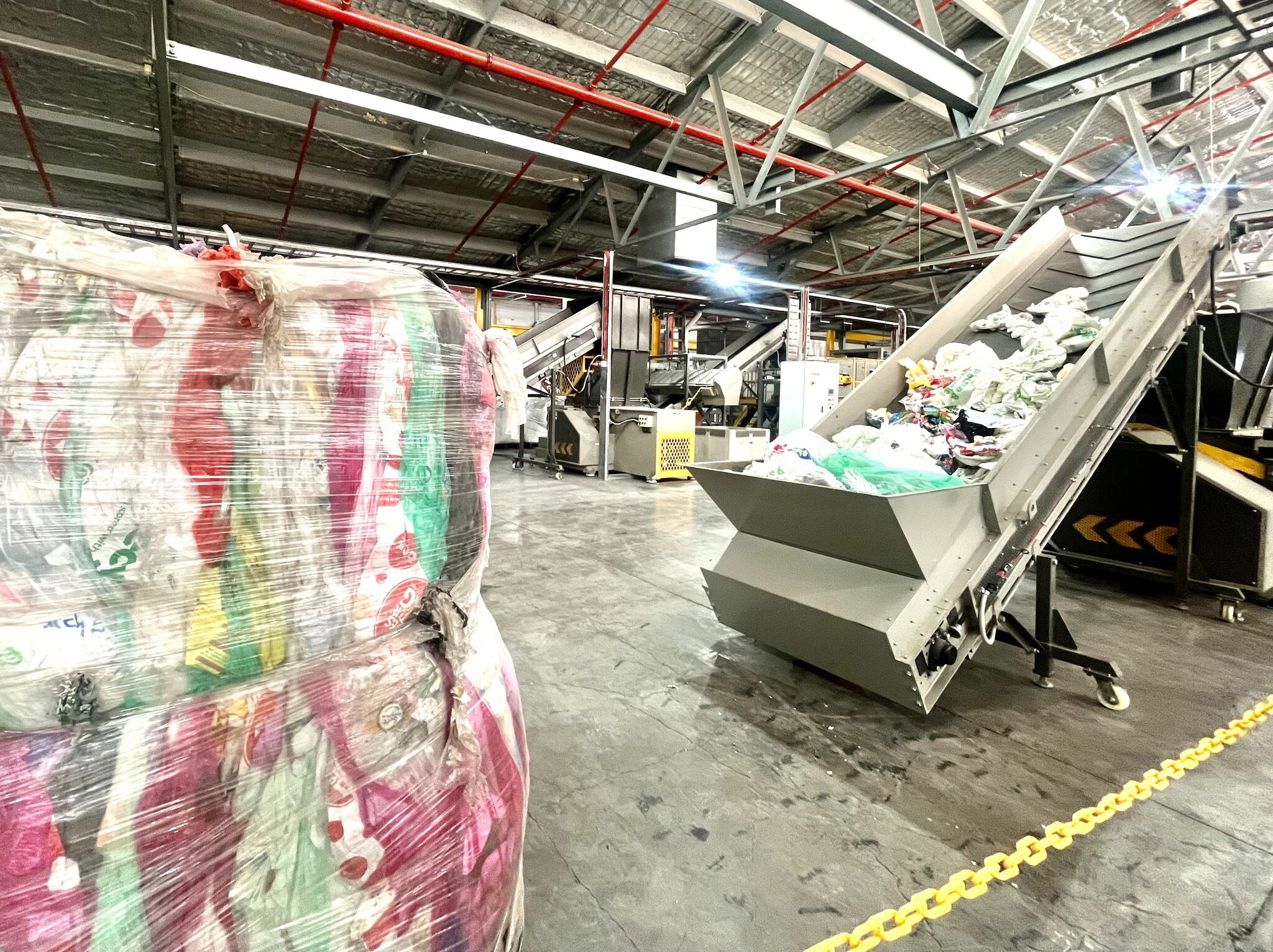 Machines turning plastic waste into eco-concrete and low-carbon building materials at Victoria's new RESIN8 recycling facility